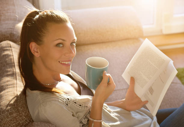 istock Woman reading book and drinking coffee 852085816