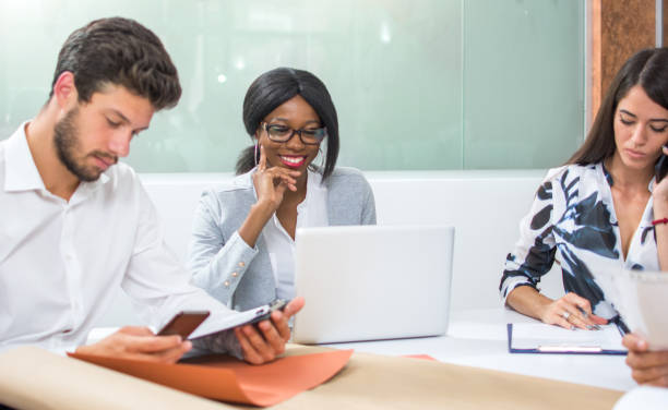istock Group of business people working separately on the same table in office. 852086244