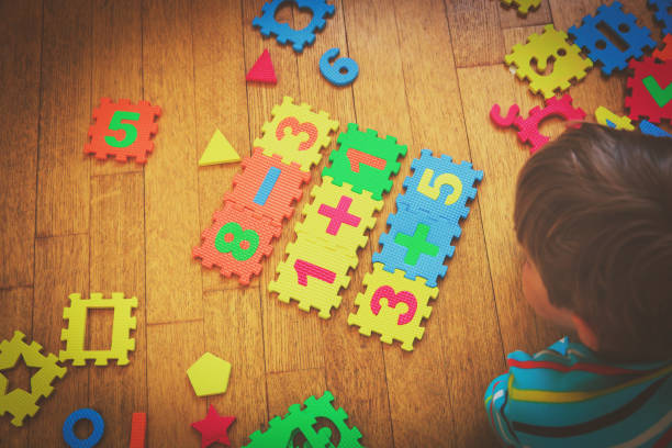istock little boy playing with puzzle, education concept 852092212