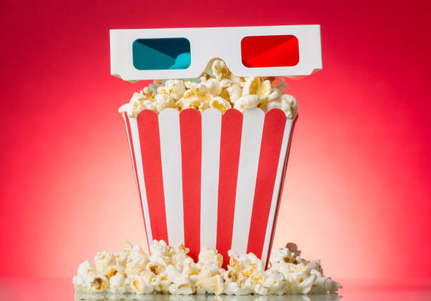 istock Popcorn and 3D glasses, isolated on red 852092442