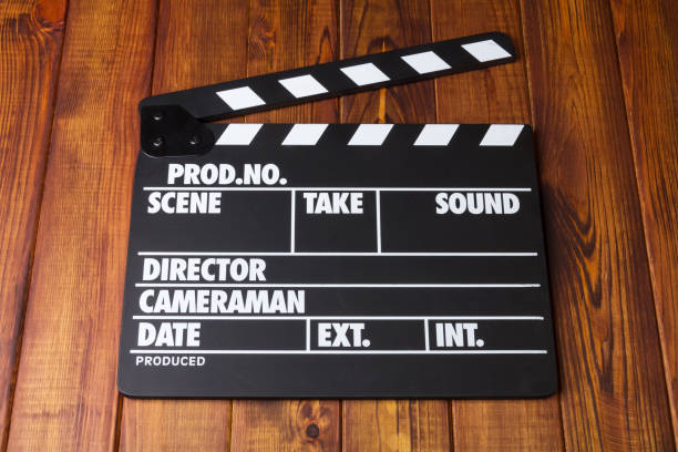 istock Black with white letters clapper against dark wood. 852092450