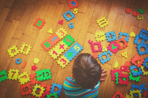 istock little boy playing with puzzle, education concept 852092852