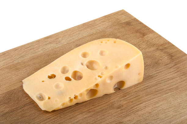 istock piece of cheese on a wooden table isolated on a white background 852094340
