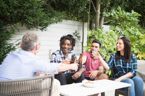 istock Group of friends enjoying drinks in garden 852102584