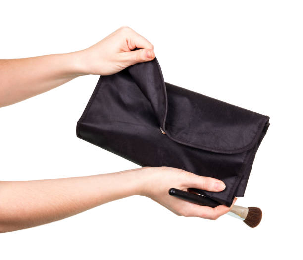 istock In female hands a cosmetic brush and a case is isolated on a white. 852102940