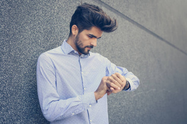 istock Businessman checking the time outdoors. Man looking at watch. Space for copy. 852102978