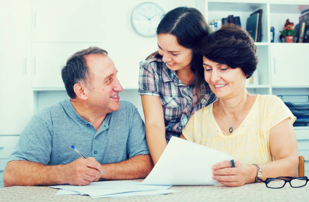istock Daughter helping with documents to parents 852103730