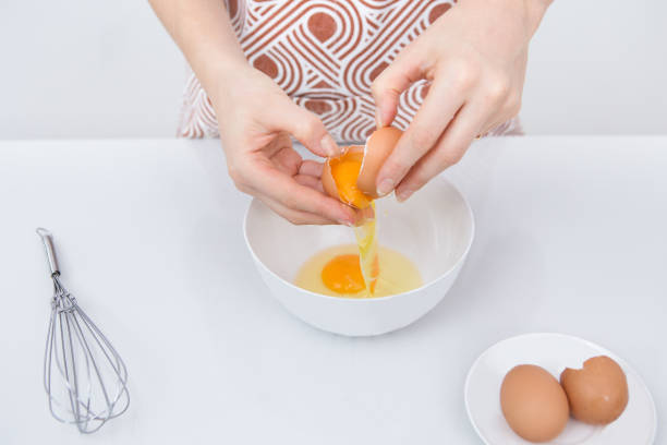 istock Close-up of female chef cracking egg 852106212