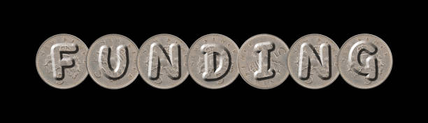 istock FUNDING – Coins on black background 852106582