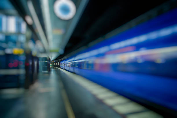 istock subway train passing through station, passengers waiting on the platform 852106778