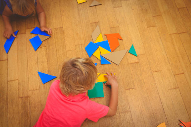 istock kids playing with puzzle, education concept 852106786