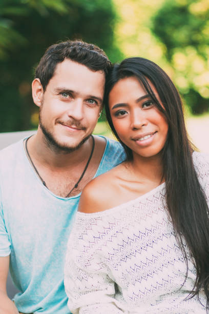 istock Content Young Man Embracing Asian Girlfriend 852107088