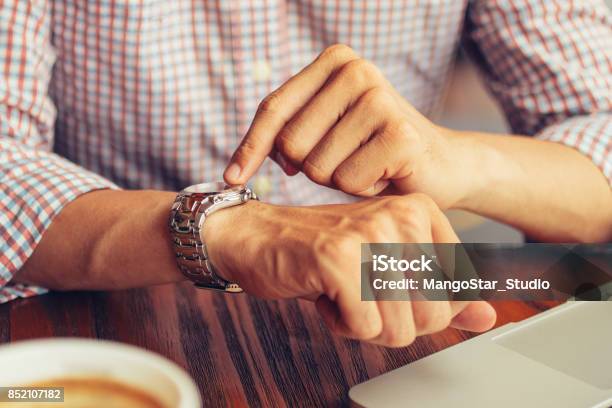 Male Manager Pointing At Watch And Sitting In Cafe Stock Photo - Download Image Now - Deadline, Clock, Abstract