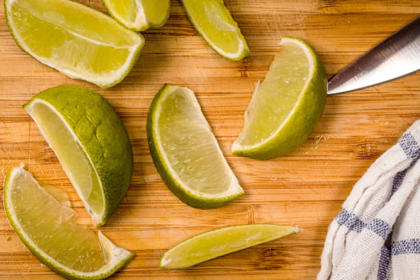 istock Fresh lime slices on a wooden cutting board 852107584
