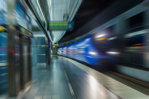 istock subway train passing through station, passengers waiting on the platform 852110714