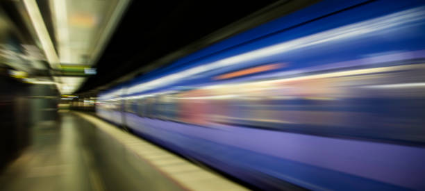 istock subway train passing through station, passengers waiting on the platform 852111720