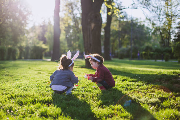 istock Little girls playing on grass 852115944