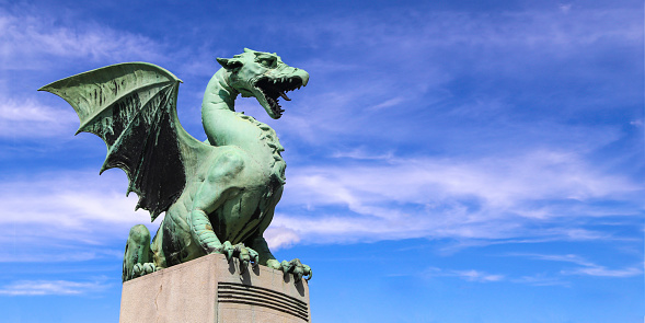 Dragon statue on famous Dragon bridge (Zmajski most) in Ljubljana, Slovenia.