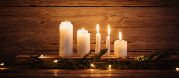 istock Christmas candles on wooden background 852120662