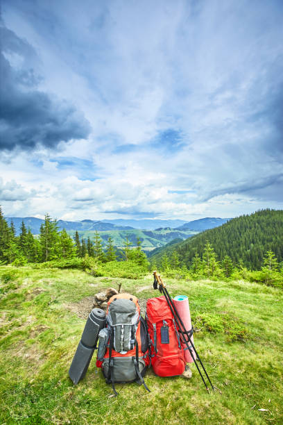 istock Backpacks in the mountains overlooking the mountains on the green grass. 852126166