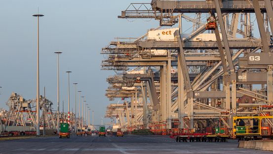 ROTTERDAM, NETHERLANDS - JUL 9, 2013: Automated Guided Vehicles (AGV) moving shipping containers in a container  terminal in the port of Rotterdam.