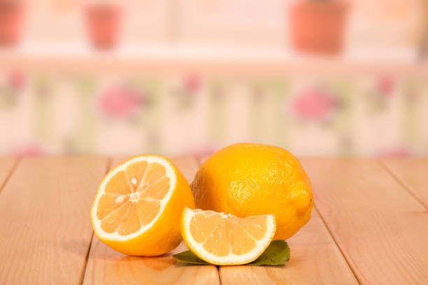 istock A ripe lemon half and piece on the background of the kitchen. 852129418