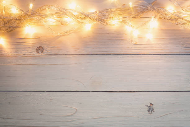 istock christmas background and lights garland on wood background with space. 852134236