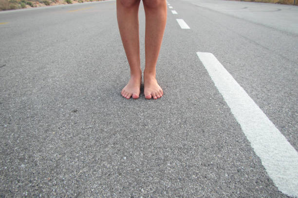 Barefoot Woman On Asphalt Road