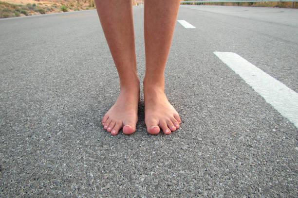 Barefoot Woman On Asphalt Road