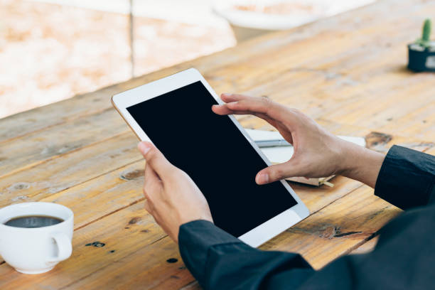 istock Business man hand holding tablet in coffee shop. 852135666