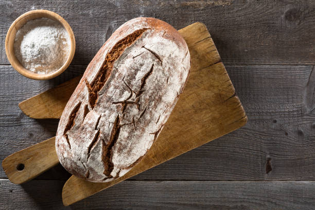 istock Baked bread on wooden background 852137860