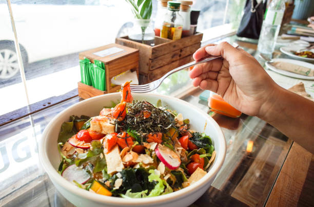 istock fork on hand, eating mix vegetable , salmon salad 852148518