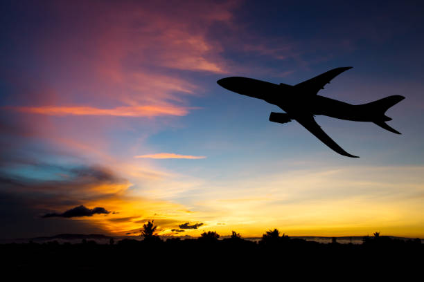 istock Silhouette airplane taking off flight with blue and red sky background 852149346
