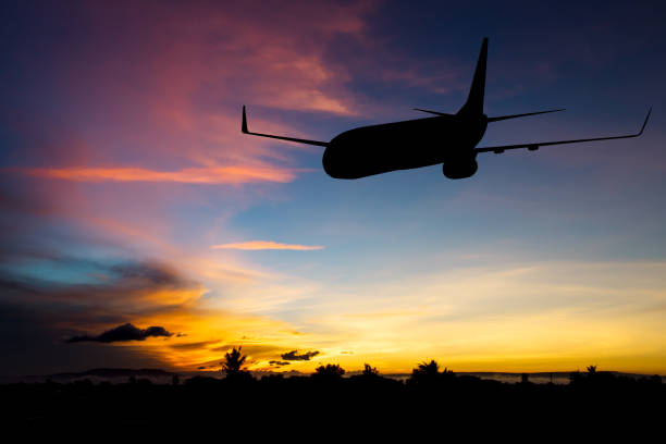 istock Silhouette of airplane taking off flight with blue sky background 852149596
