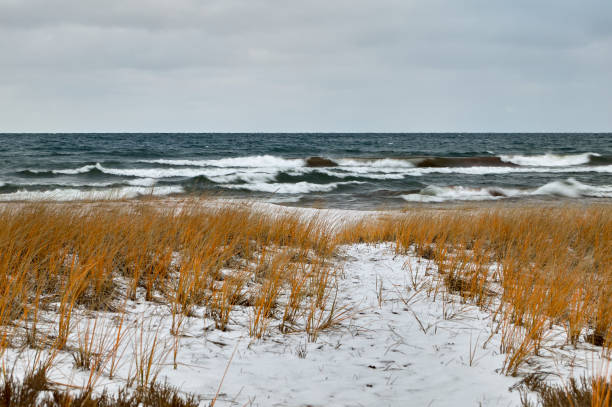 Rough lake and snow covered winter shoreline stock photo
