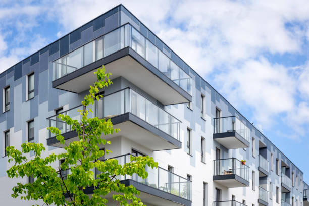 istock Green tree against apartment building 852152412