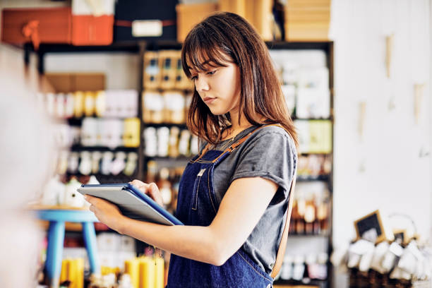 istock Beautiful young owner using digital tablet in delicatessen 852153692