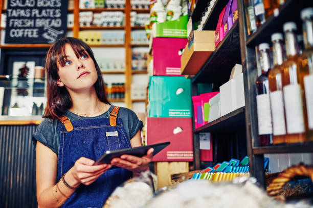 istock Female deli owner checking inventory with digital tablet in store 852153804