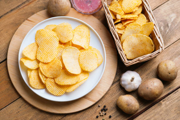 istock Crispy potato chips in a wicker basket and dish 852153810