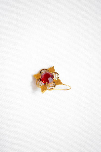 istock Gold earring with red zirconium oxide heart 852154090