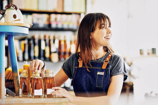 istock Deli owner arranging infused oil bottles while looking away 852154998