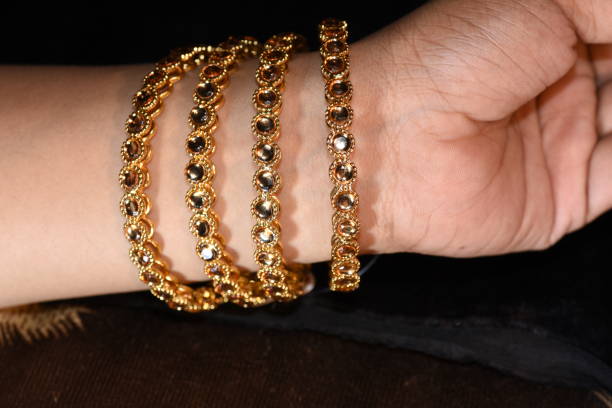 istock Fancy gold looking imitation bangles / bracelets on the woman's wrist 852158044