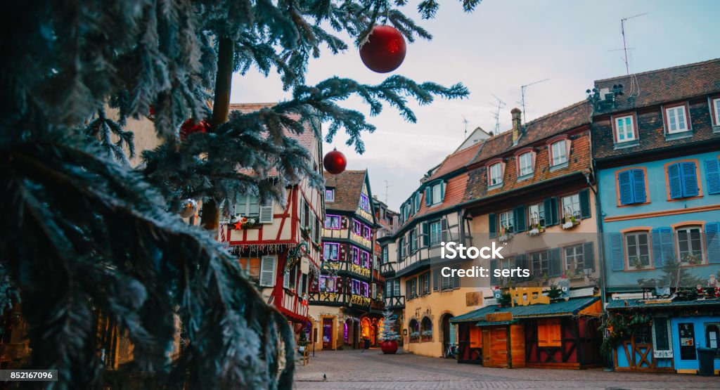 Christmas time in Colmar, Alsace, France Old town decorate magical like a fairy tale in Noel festive season with detail of Christmas tree with red ball ornates at early morning time in Colmar, Alsace, France. Christmas Market Stock Photo