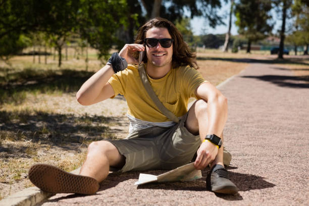 istock Tourist man with map talking on mobile phone 852173722
