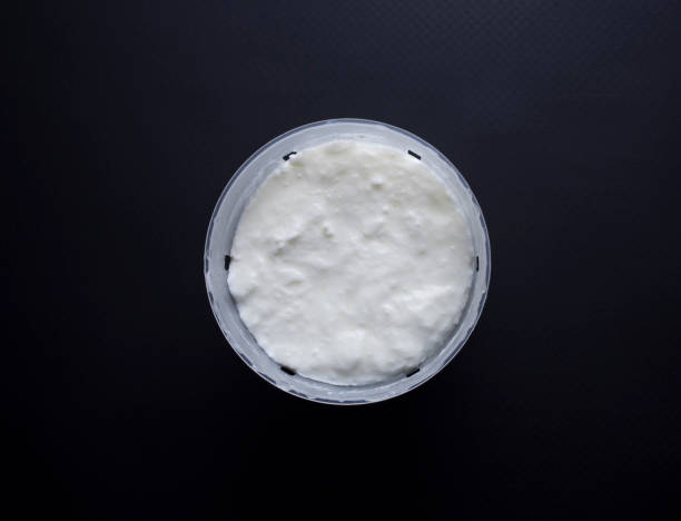 istock Fromage blanc in cheese basket isolated on black 852174550