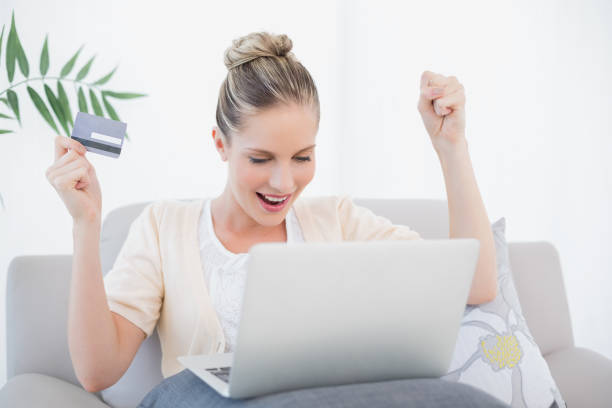istock Victorious fresh model shopping online using laptop 852185230