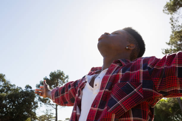 istock Man standing with arms outstretched in the park 852185388