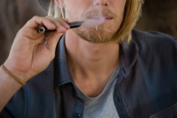 istock Man smoking an electronic cigarette in the park 852187884