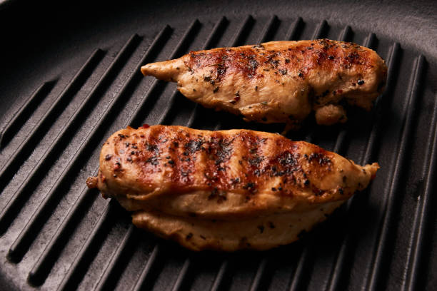 istock Grilled chicken breast fillets on black ribbed cooking pan 852188240