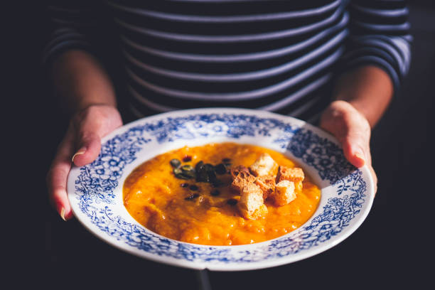 Pumpkin Soup with Croutons and Pumpkin Seeds Pumpkin Soup with Croutons and Pumpkin Seeds squash soup stock pictures, royalty-free photos & images